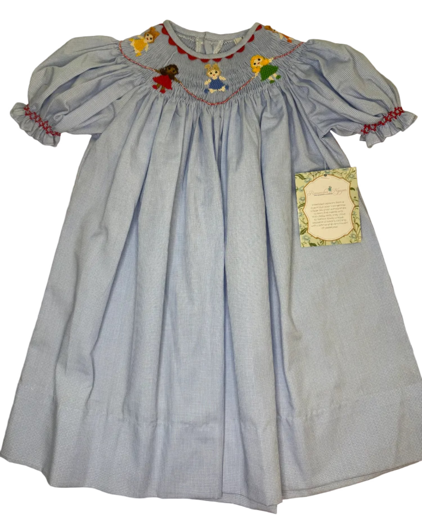 Light blue smocked girls dress with puff sleeves and embroidered children on collar