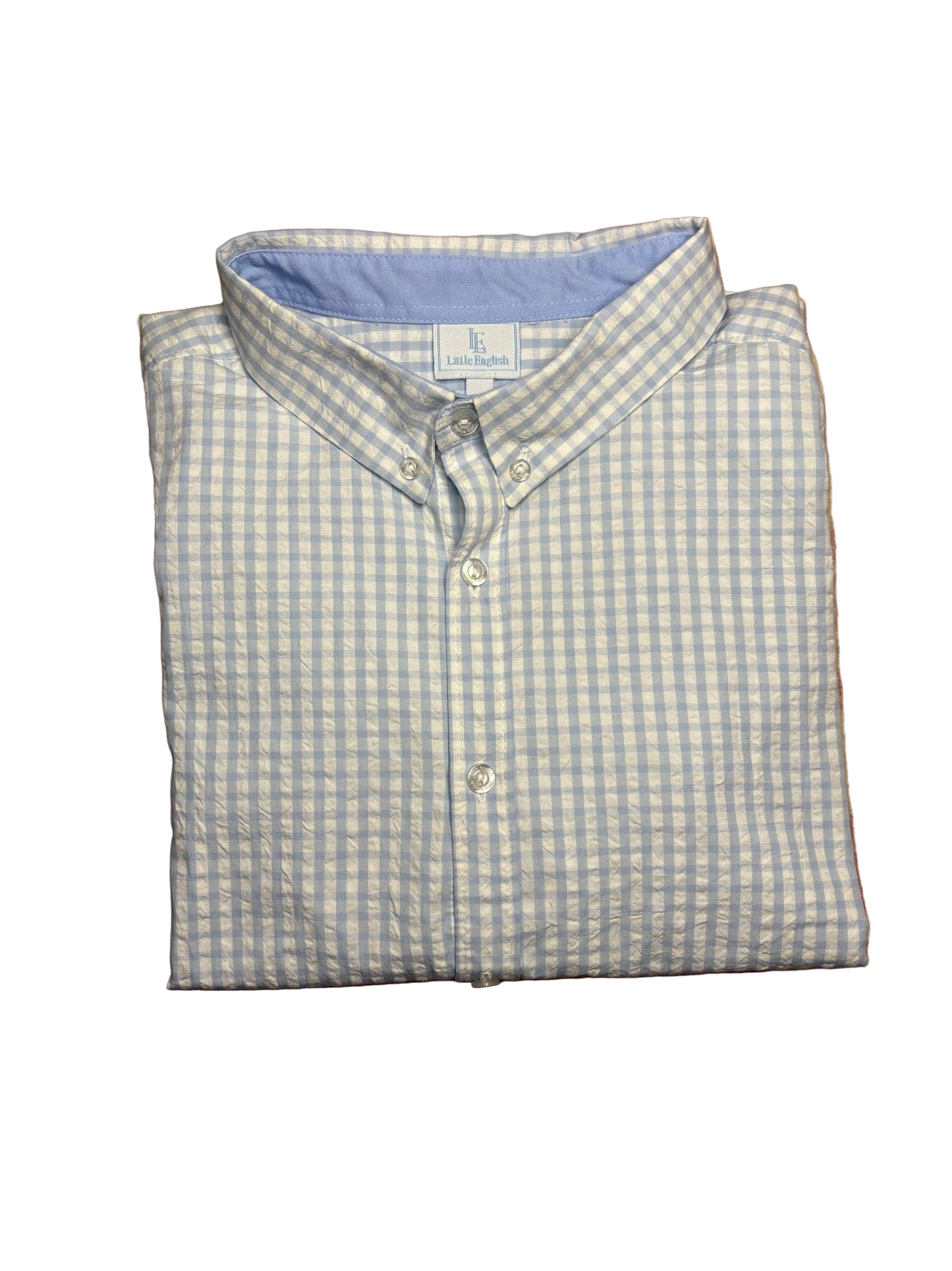 Folded blue and white gingham button-down children’s shirt with collar on white background