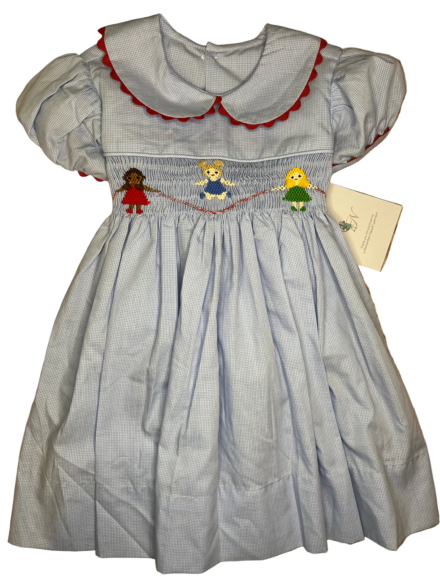 Blue gingham smocked girls dress with puff sleeves, red trim, and embroidered children