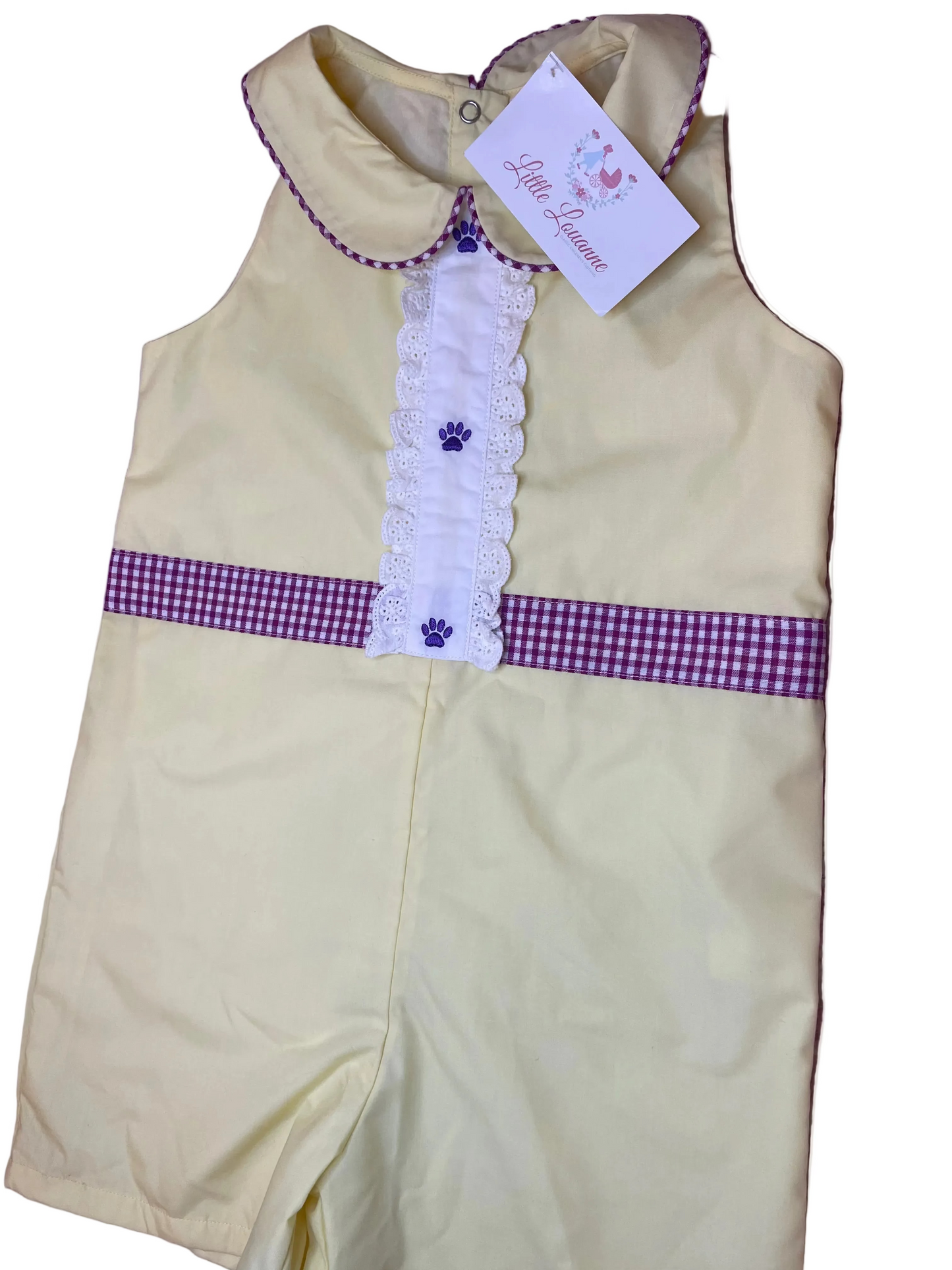 Yellow sleeveless toddler romper with purple trim, gingham waistband, and lace details.