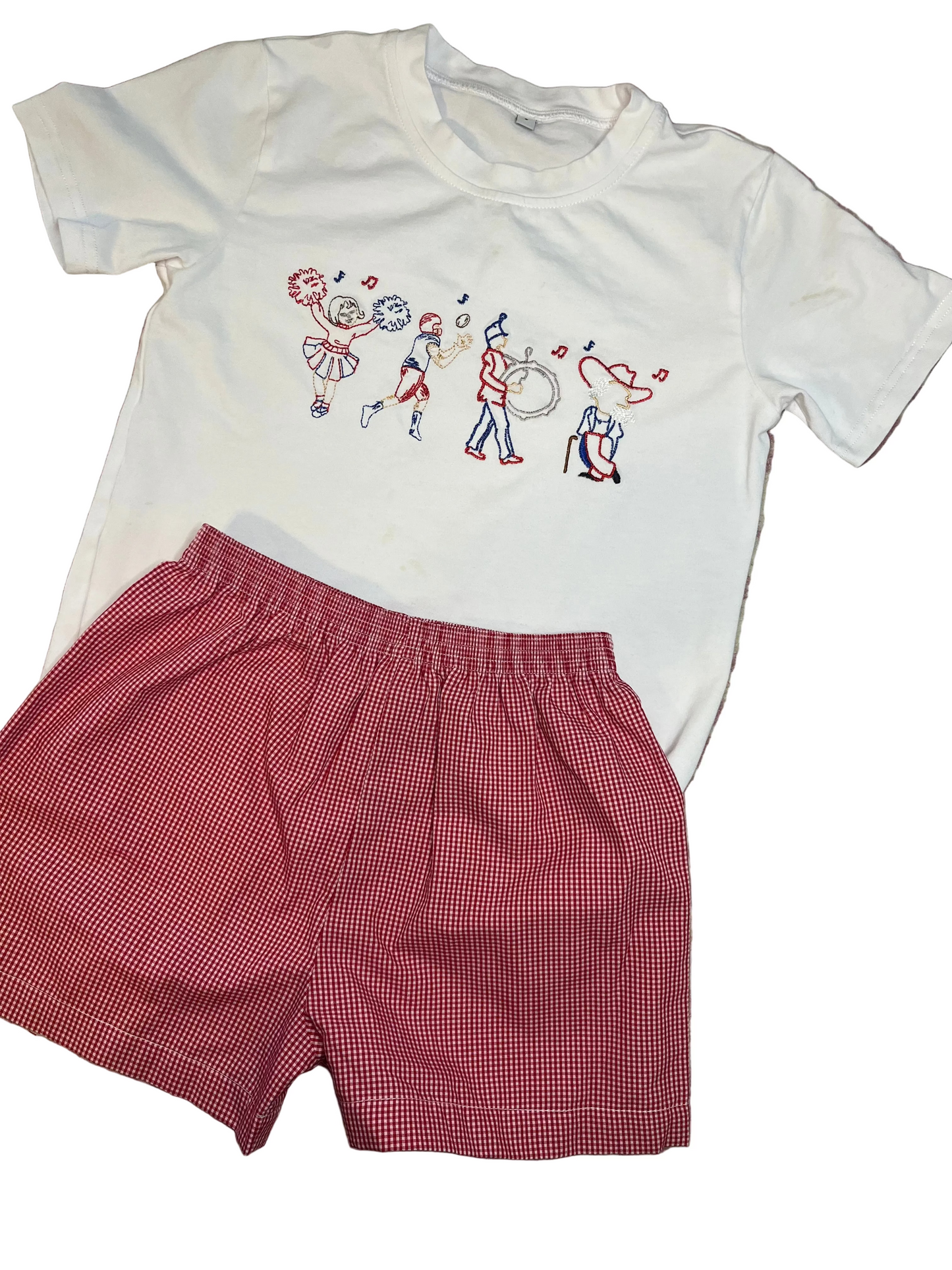 Children’s outfit with white t-shirt featuring parade embroidery and red gingham shorts