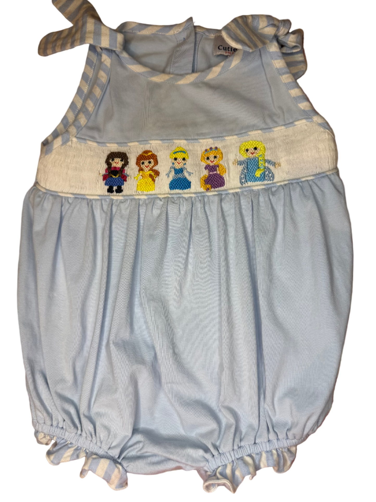 Light blue baby romper with cartoon character band on a patterned surface