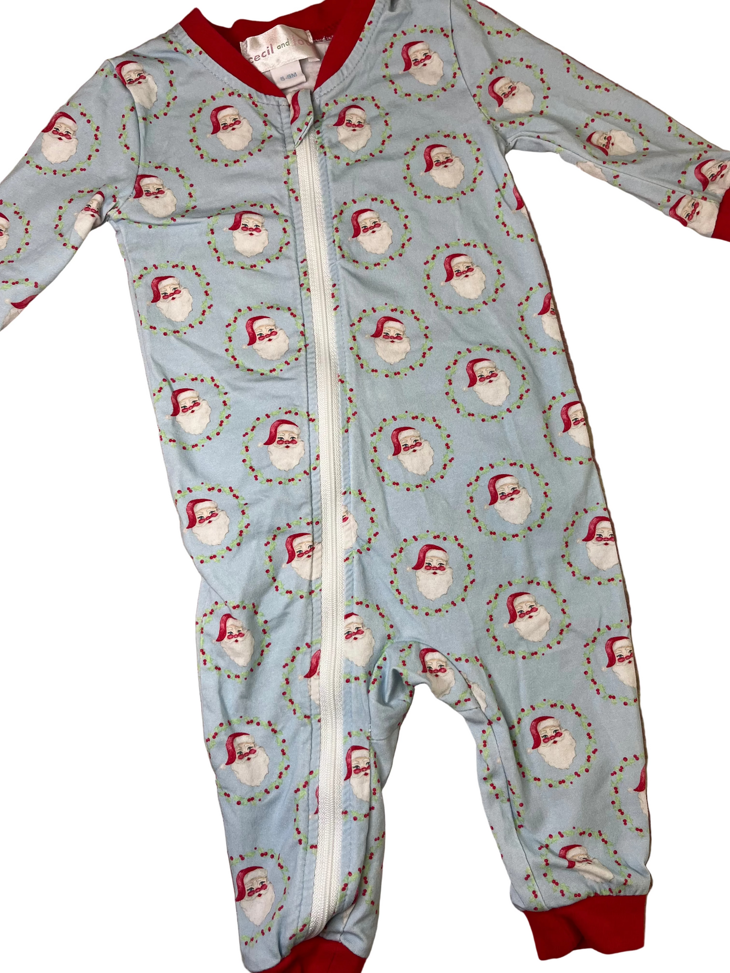 Light blue children's Christmas romper with Santa print, zipper front, and red trim cuffs.