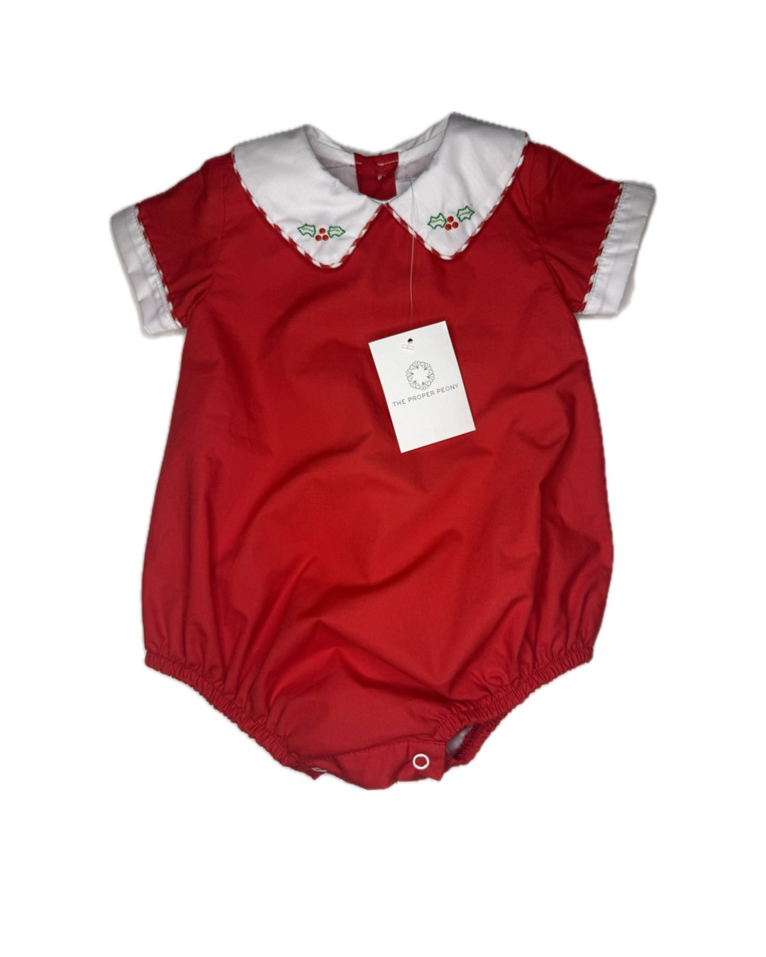 Red baby romper with white scalloped collar, short sleeves, and festive holly embroidery