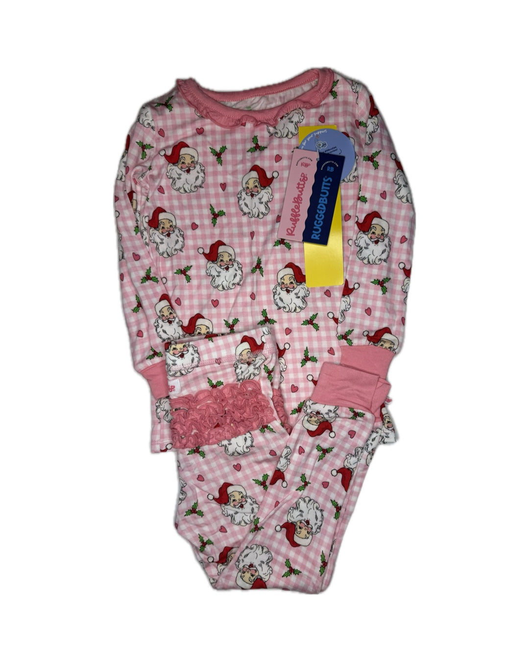 Pink children's Christmas pajamas with Santa Claus print and ruffle details, tags attached