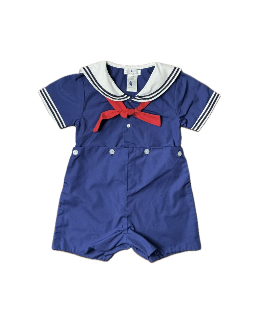 Navy blue children's sailor romper with white collar, short sleeves, and red necktie