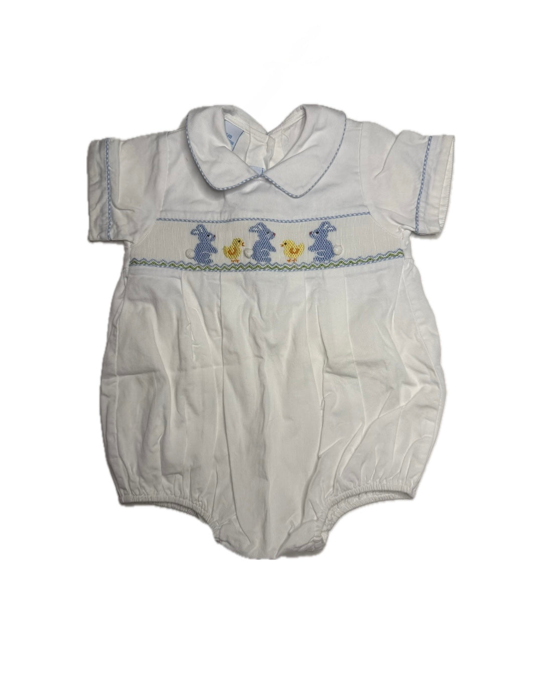 White baby romper with embroidered design on a white background