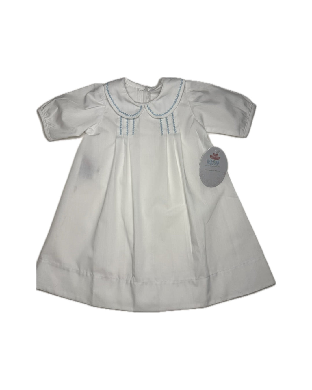 White classic baby dress with blue embroidered details and Peter Pan collar, displayed flat