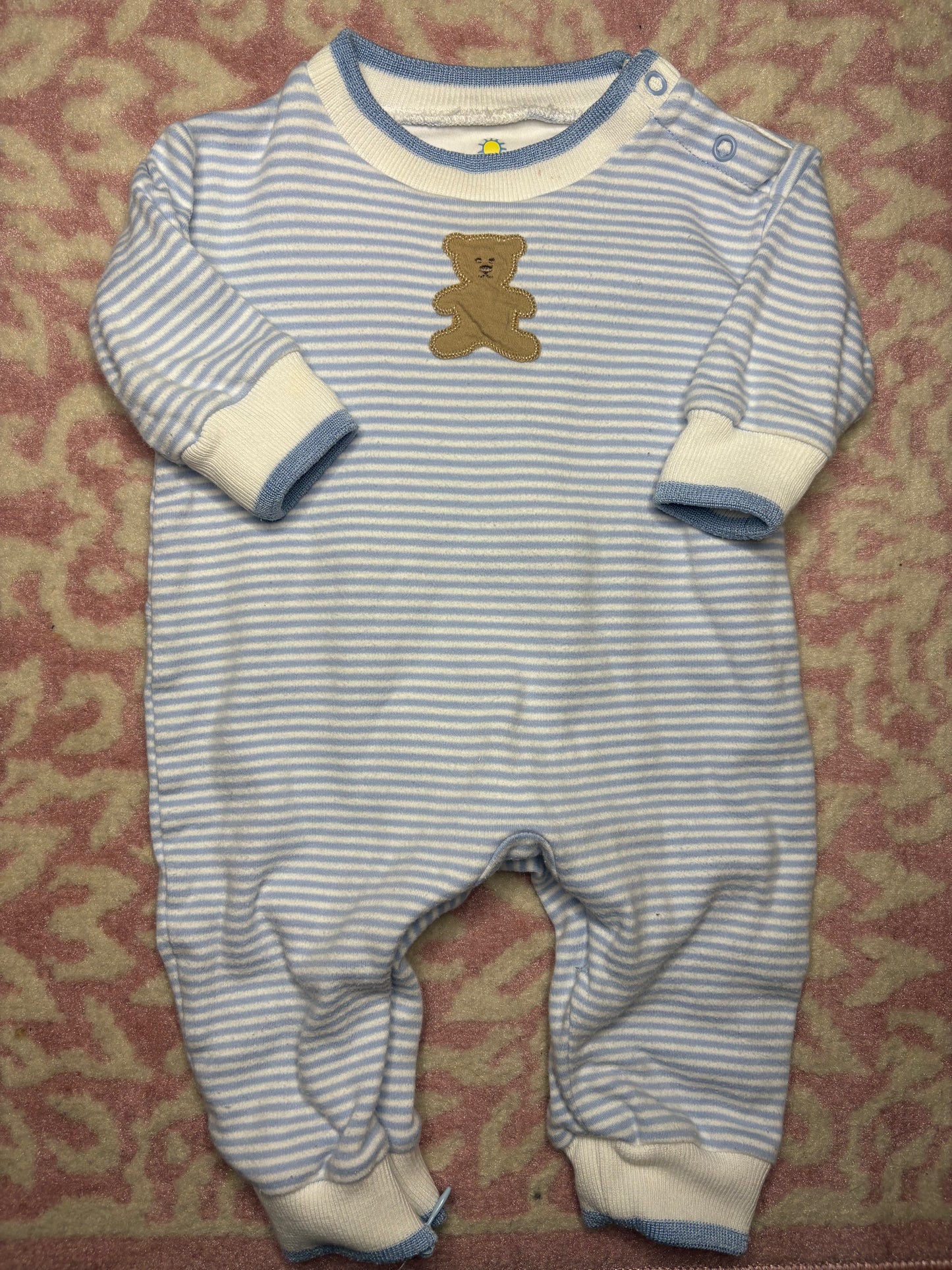 Blue and white striped baby romper with bear applique, long sleeves, and snap buttons