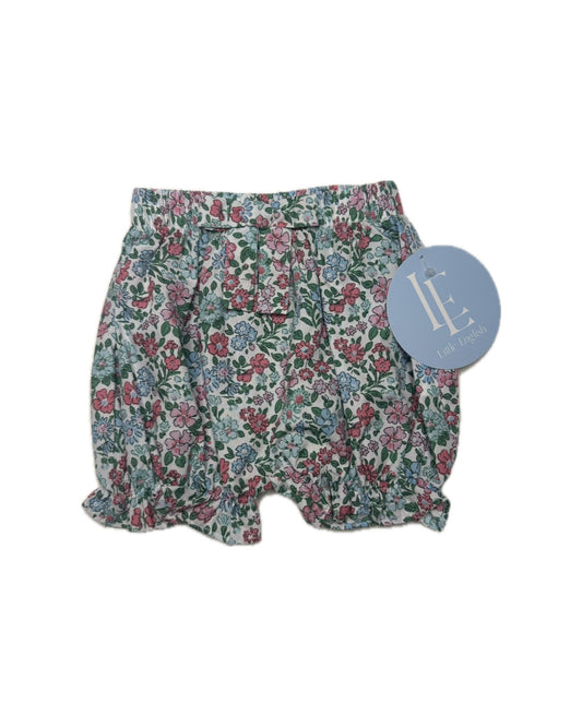 Floral patterned shorts with a brand tag on a white background