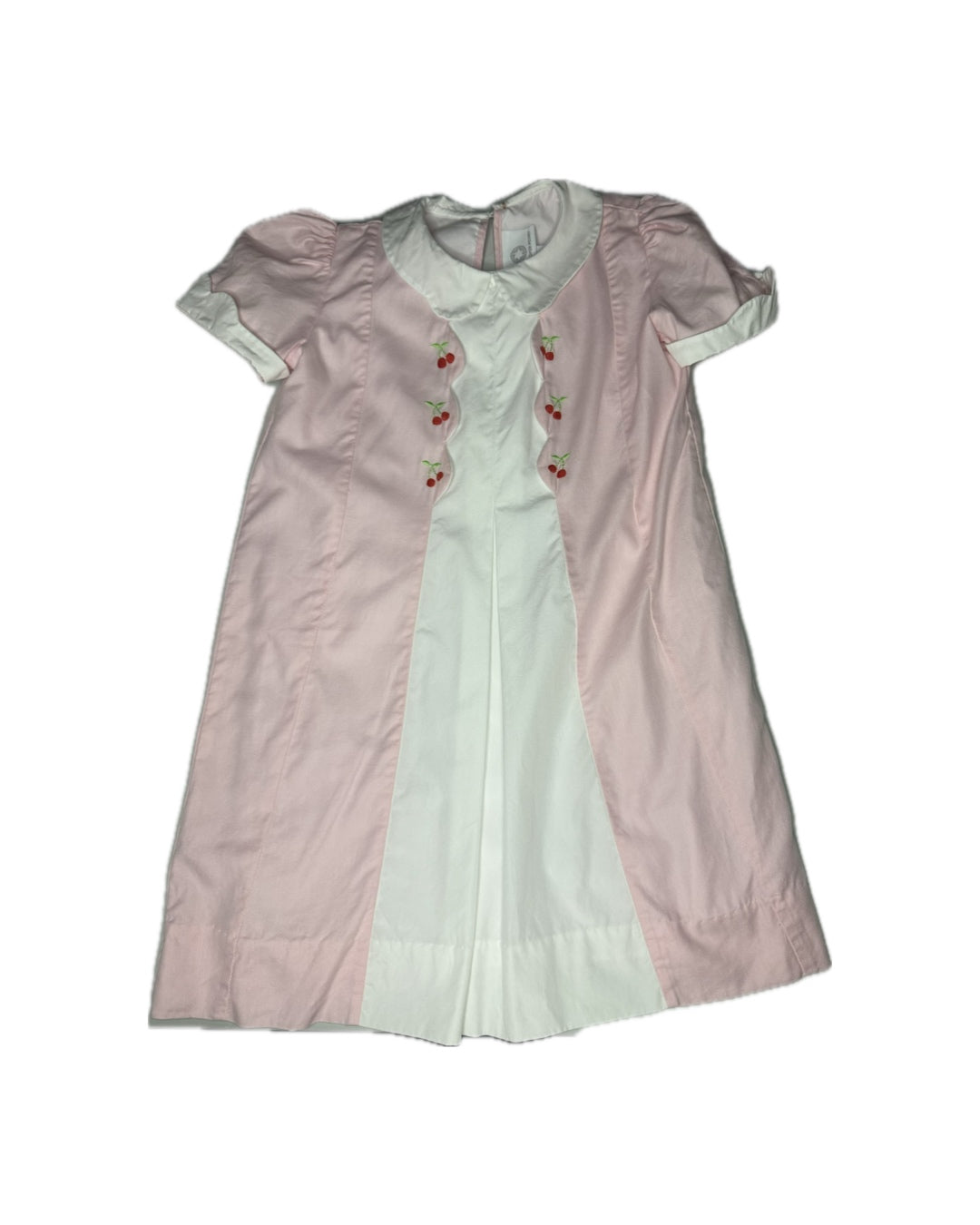 Two vintage dresses, one pink and one white with red buttons, on a white background.