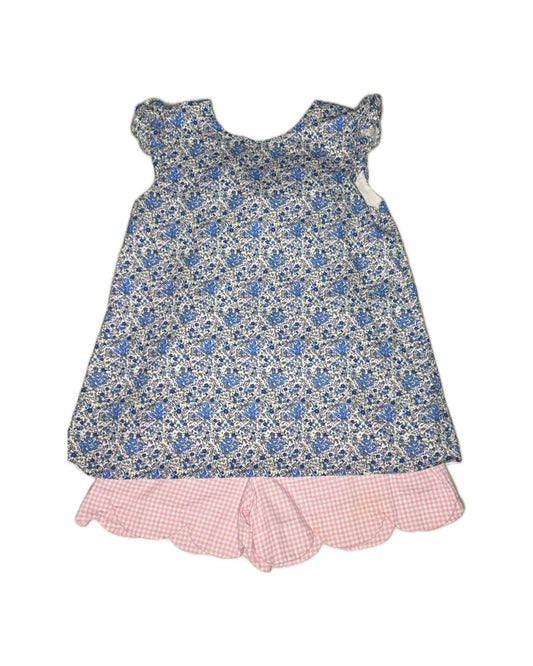 Floral dress with pink ruffled hem on a white background