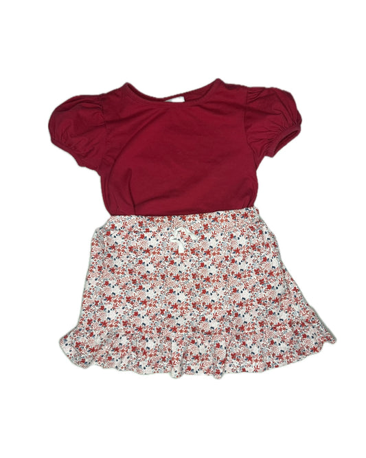 Red blouse with puff sleeves and a floral skirt on a white background