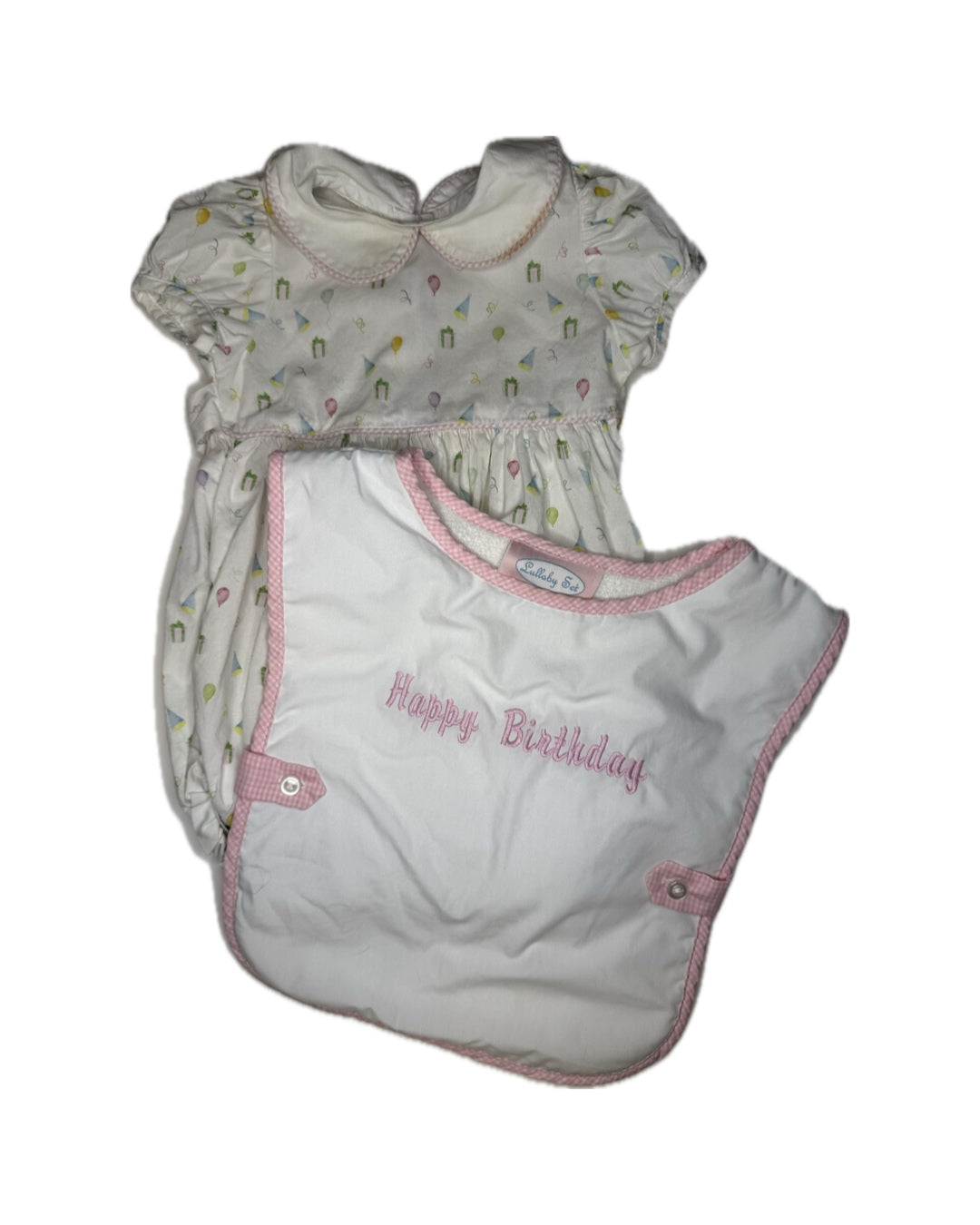 Girls' white birthday romper with pastel print and pink-trimmed Happy Birthday bib