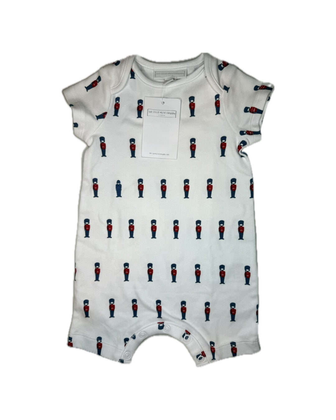 White baby romper with red and blue toy soldier print and snap closures